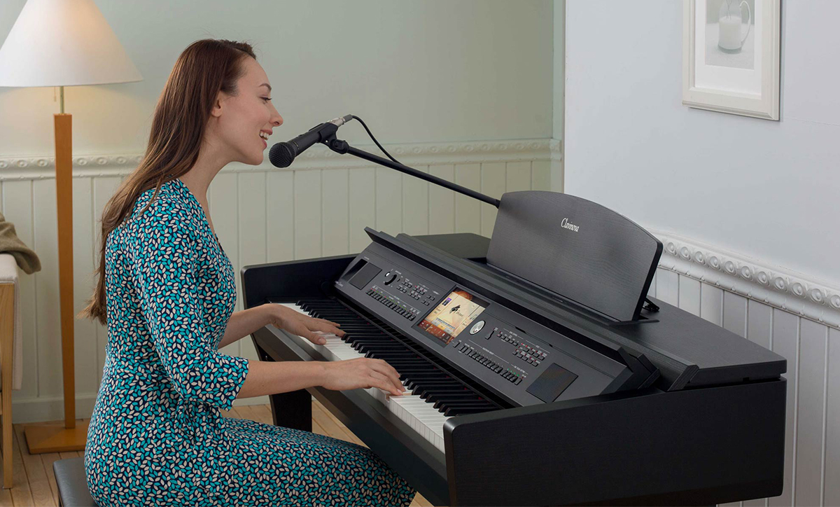 A woman playing a Clavinova piano