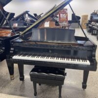 A Steinway & Sons grand piano on showroom display for a used piano sale event.