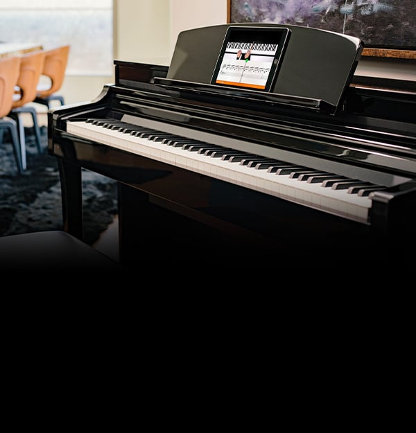Modern black piano with music display in a stylish room setting.