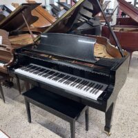 Sleek black grand piano with polished finish and ivory keys, showcasing expert craftsmanship from PianoWerke.