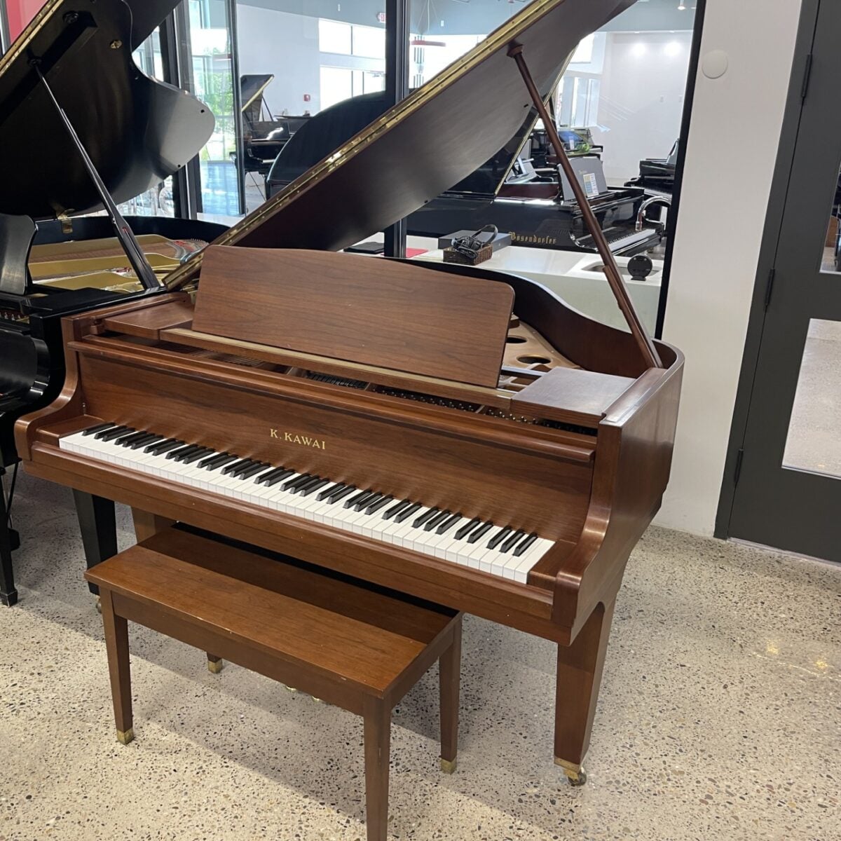 Alt text: Kawai console piano in rich mahogany finish, featuring precision keys and elegant design, ideal for any musician’s home.